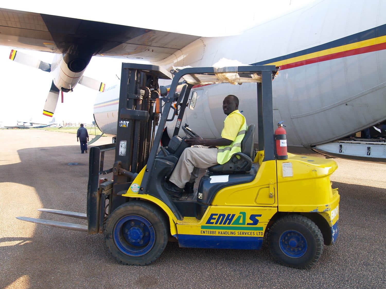 Forklift loading cargo beside an aircraft at Entebbe